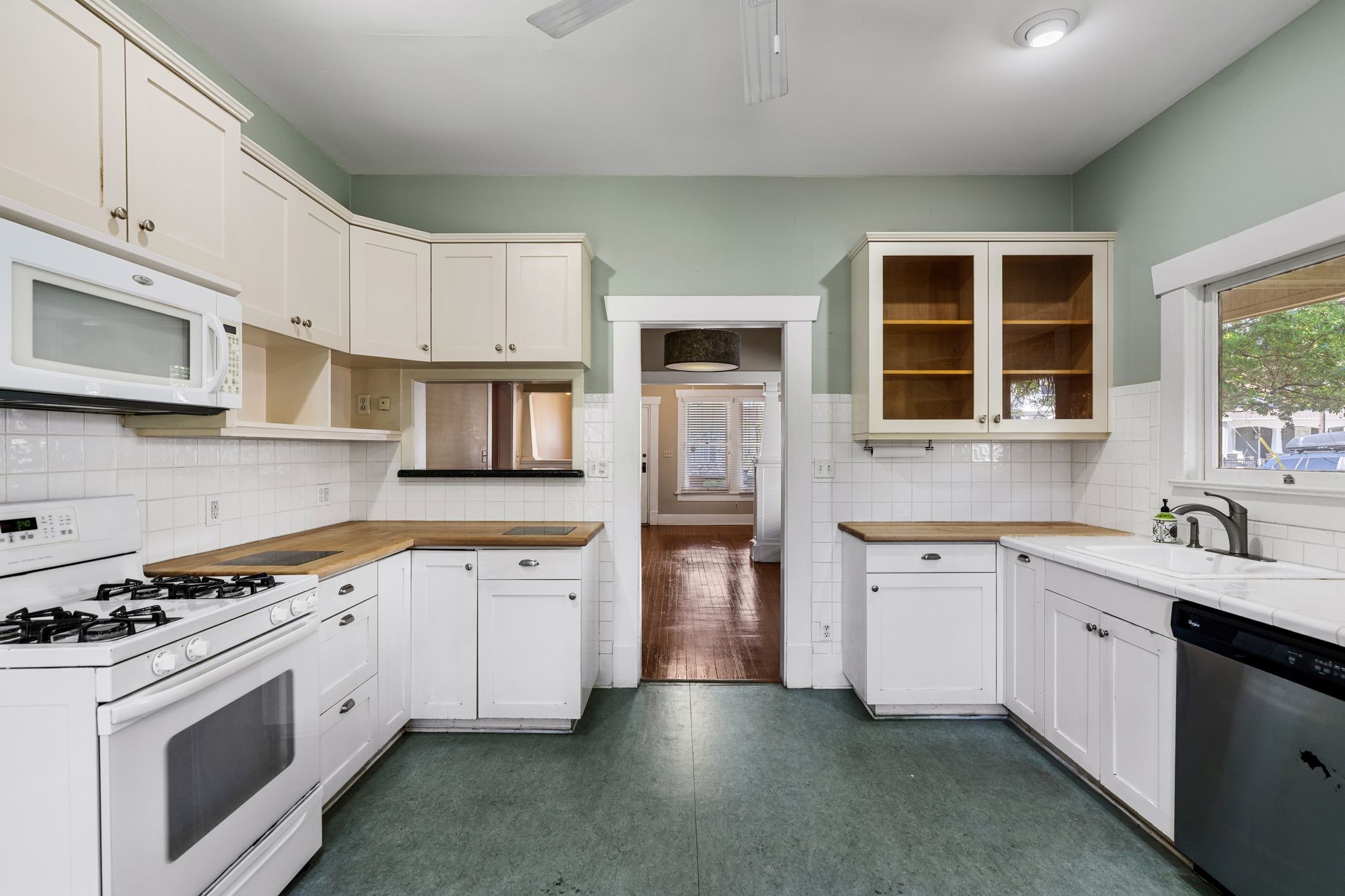217 Teetshorn Street Houston, TX 77009 - Photo 12 of 21 a kitchen with stainless steel appliances granite countertop a stove sink and cabinets
