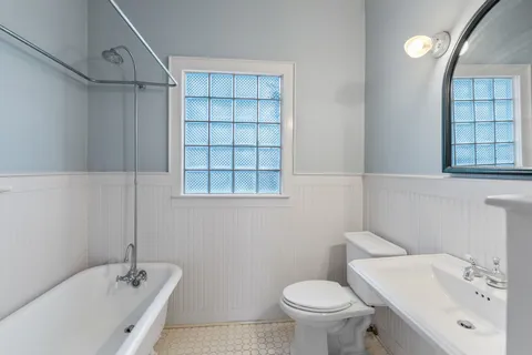 a bathroom with a sink toilet and shower