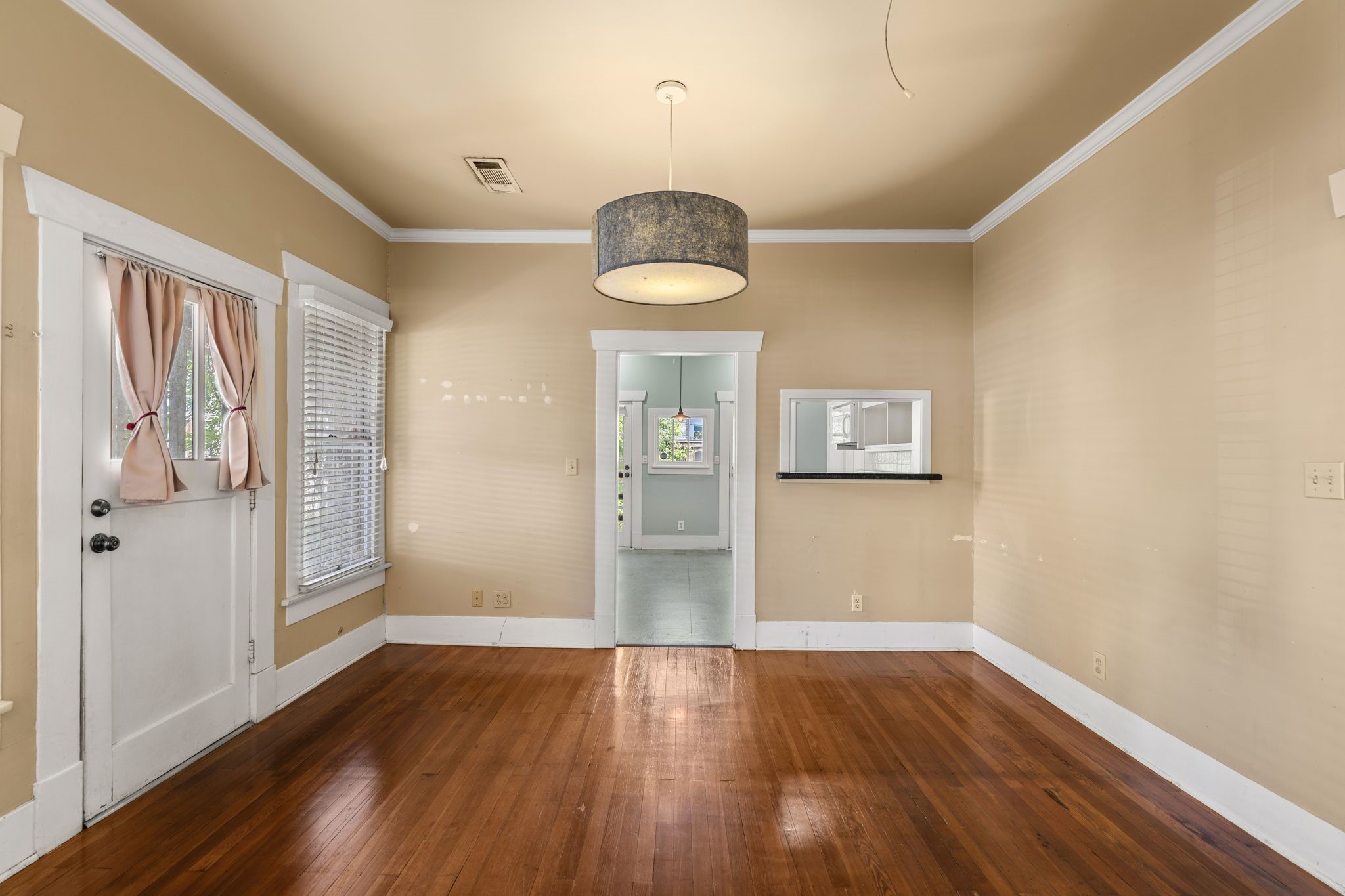 217 Teetshorn Street Houston, TX 77009 - Photo 9 of 21 an empty room with wooden floor and windows