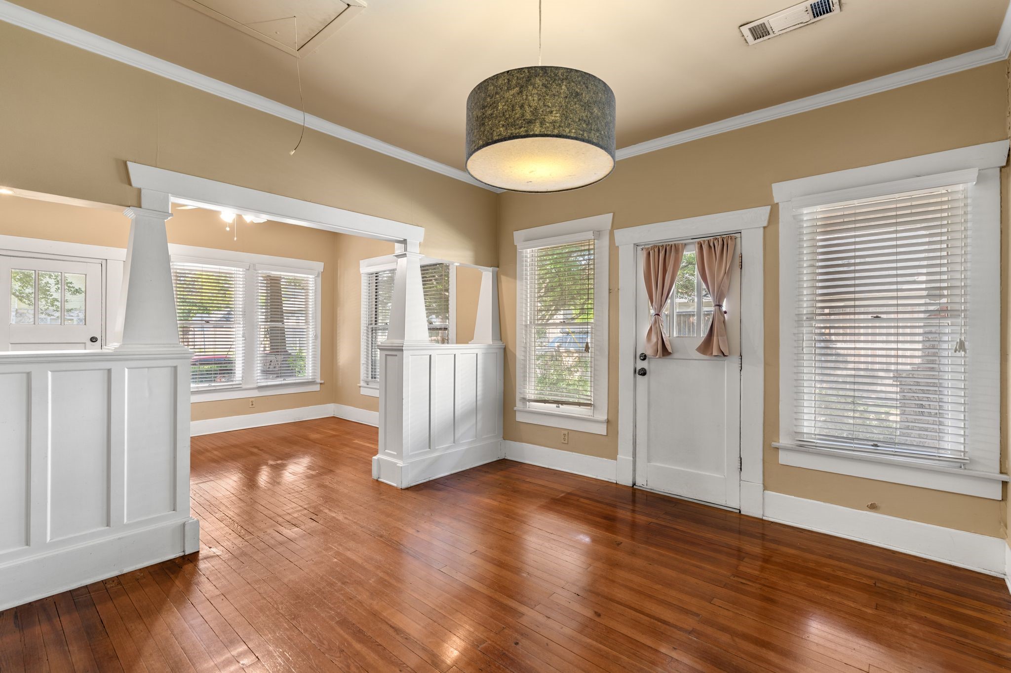 217 Teetshorn Street Houston, TX 77009 - Photo 10 of 21 a view of an empty room with wooden floor and a window