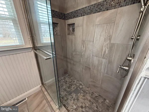 a bathroom with a shower and a sink