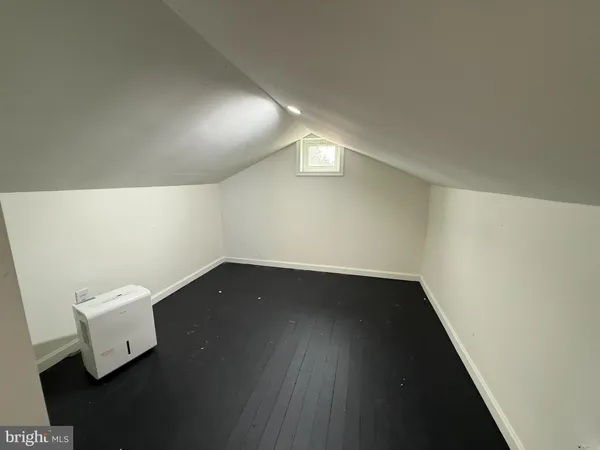 a view of an empty room and wooden floor