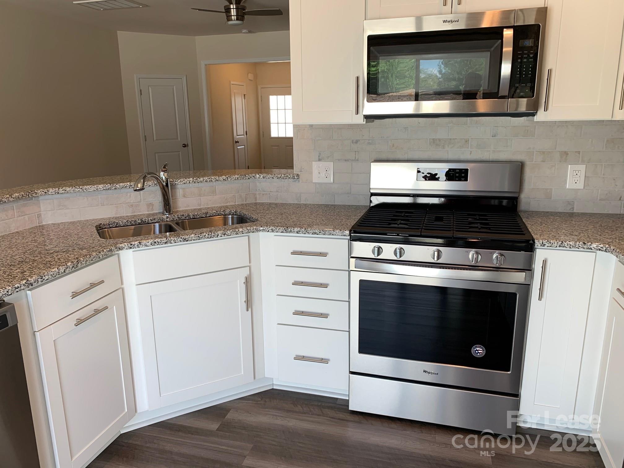 905 Wicawa Road Fort Mill, SC 29708 - Photo 14 of 29 a kitchen with stainless steel appliances a stove microwave and sink