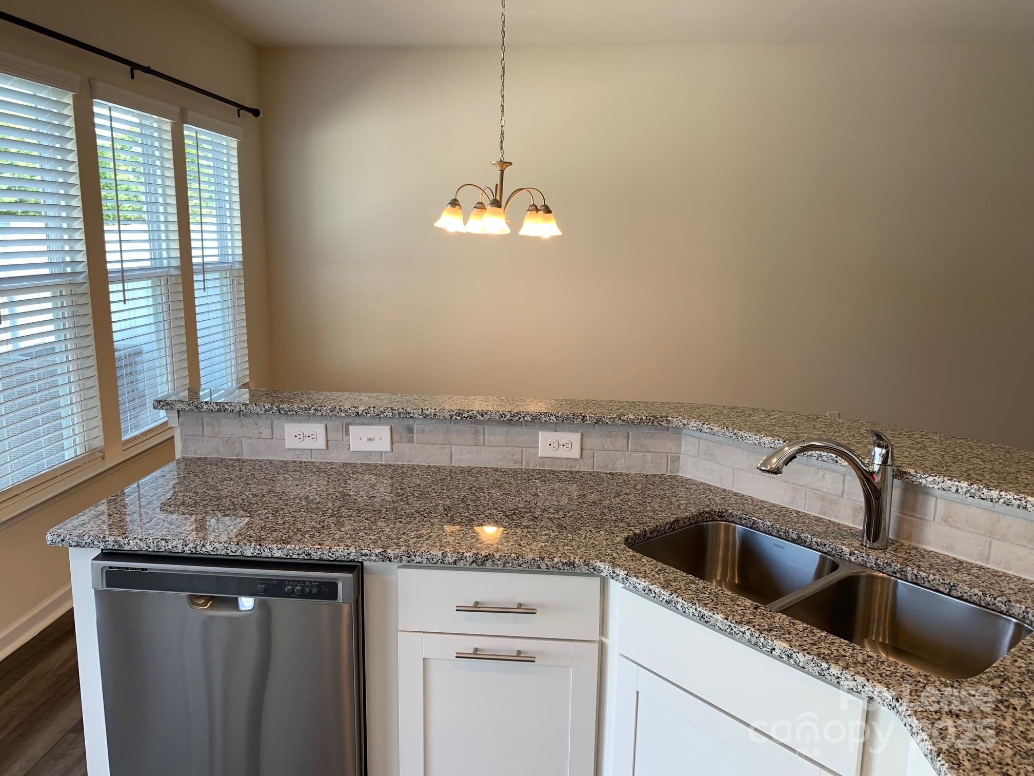 905 Wicawa Road Fort Mill, SC 29708 - Photo 15 of 29 a kitchen with granite countertop a sink cabinets and window