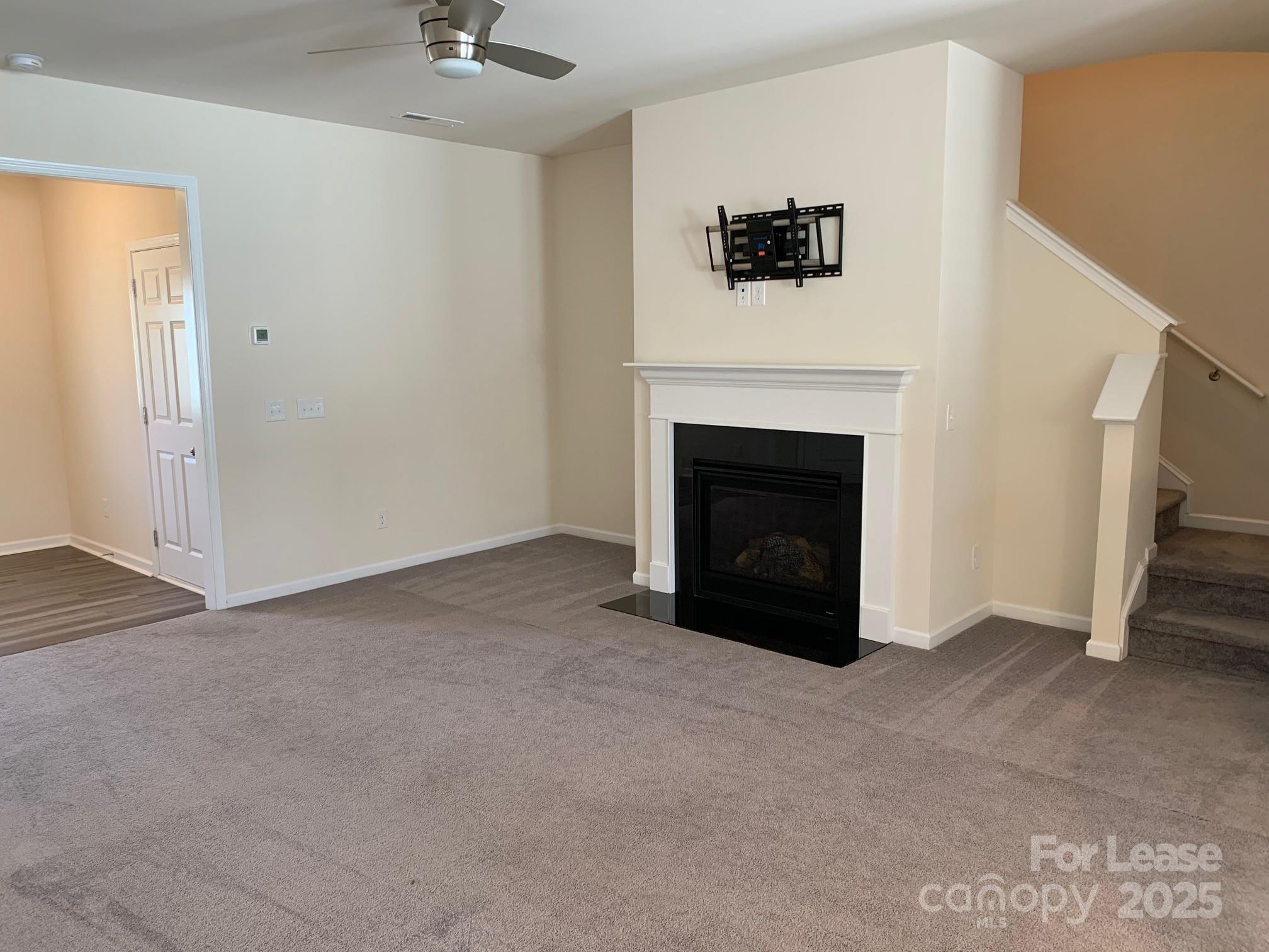 905 Wicawa Road Fort Mill, SC 29708 - Photo 8 of 29 a view of a livingroom with a fireplace and a chandelier