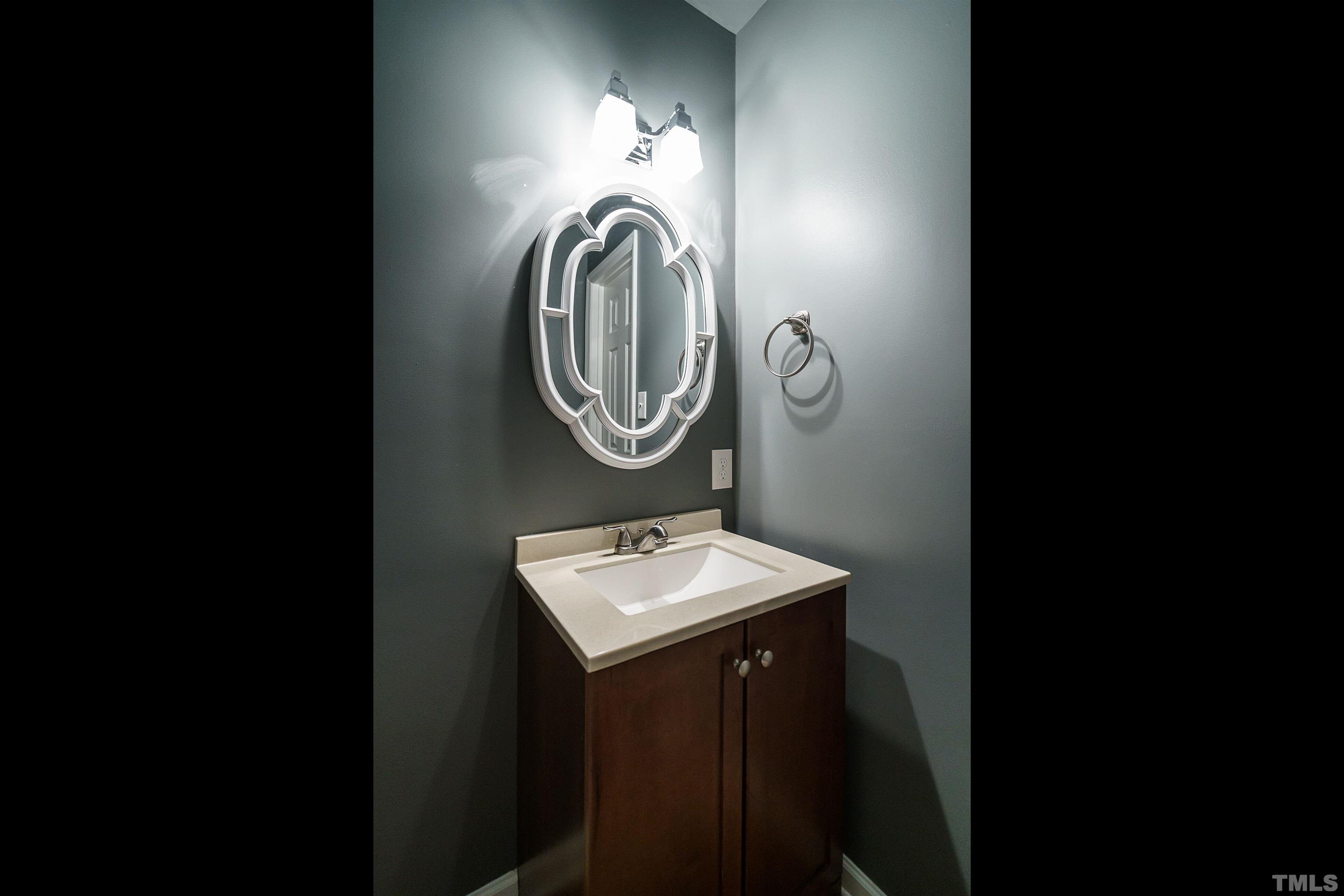 2502 Noble Road Raleigh, NC 27608 - Photo 11 of 19 a bathroom with a sink and a mirror