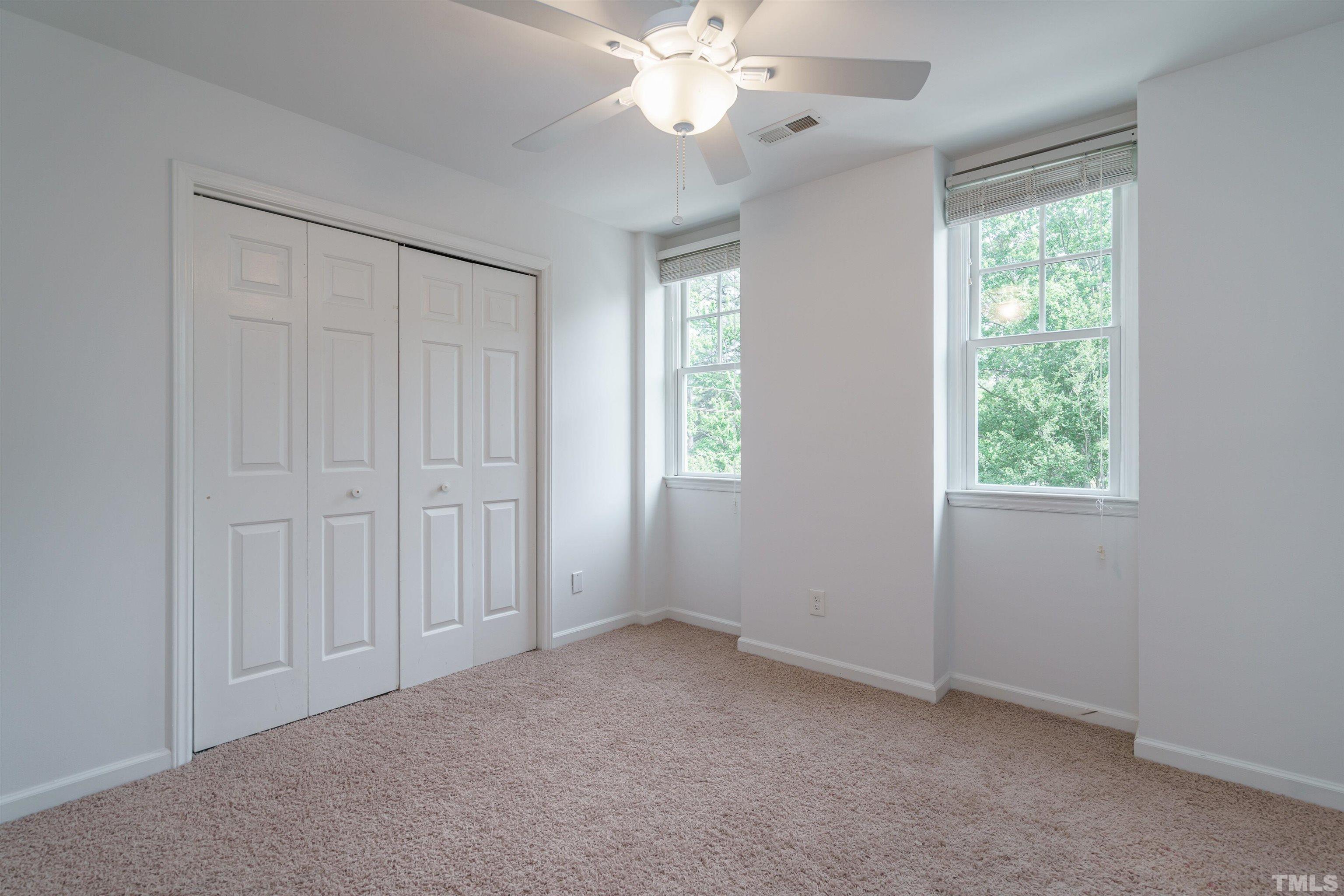 2502 Noble Road Raleigh, NC 27608 - Photo 12 of 19 an empty room with windows and fan
