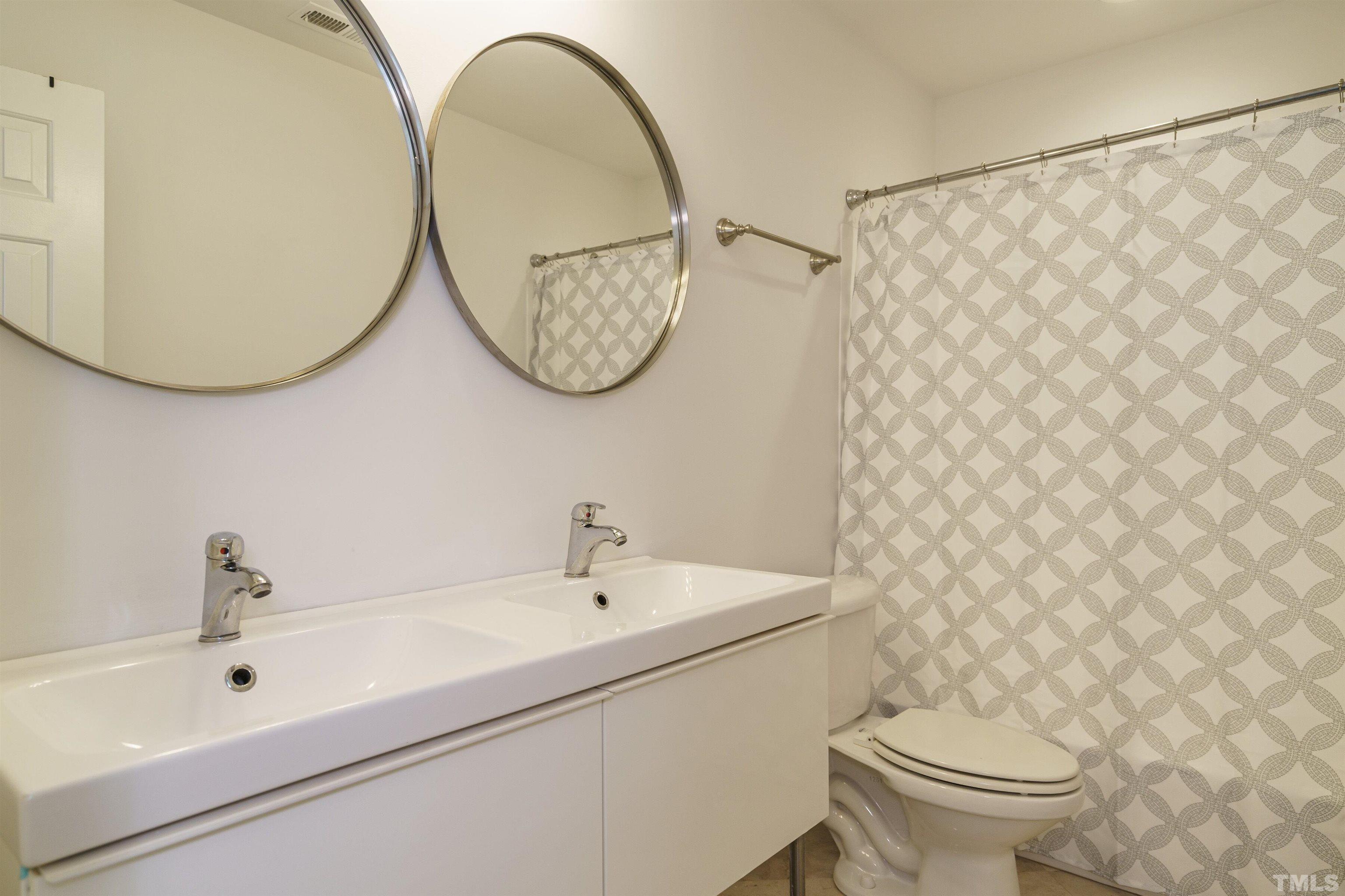 2502 Noble Road Raleigh, NC 27608 - Photo 14 of 19 a bathroom with a sink and a mirror