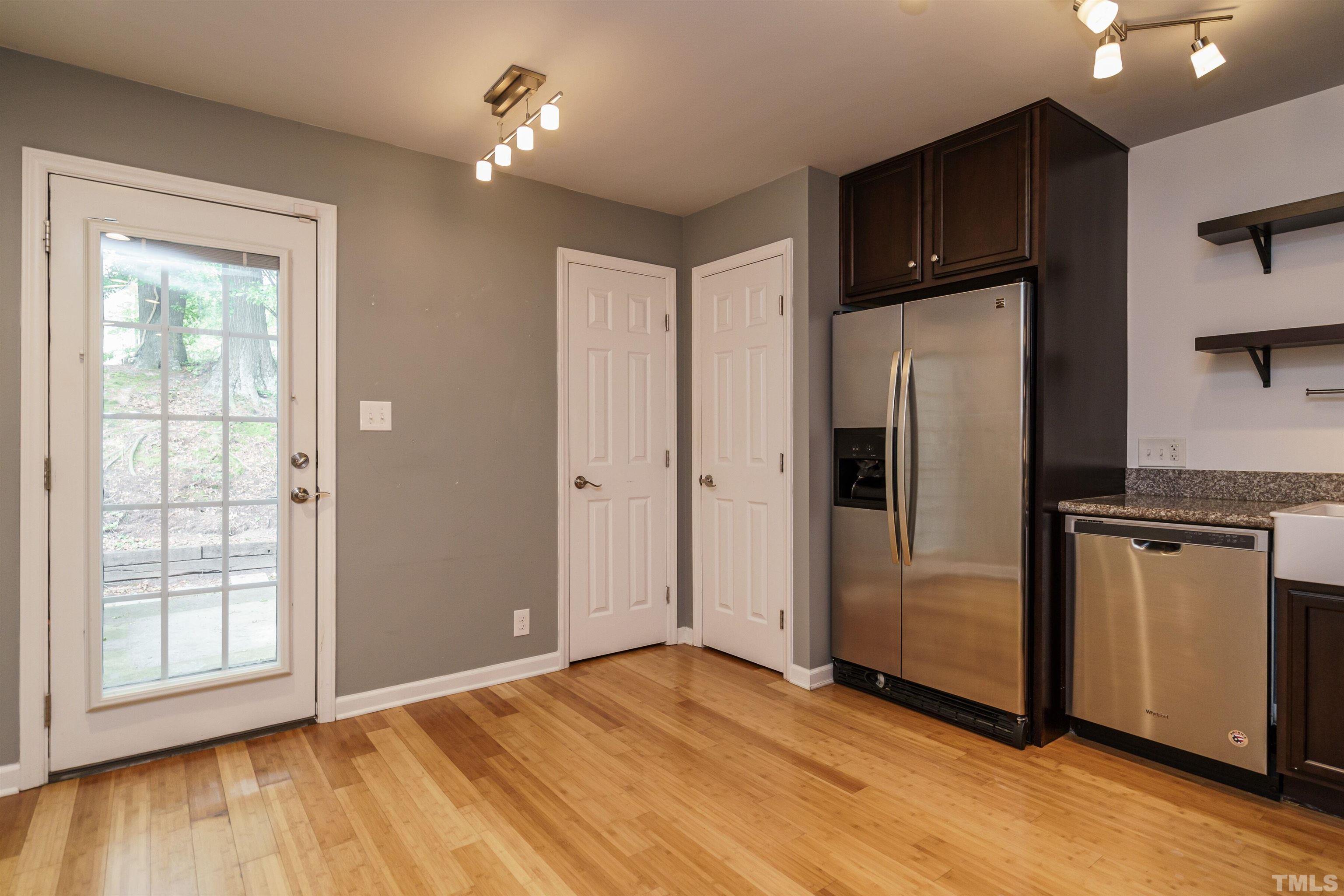 2502 Noble Road Raleigh, NC 27608 - Photo 8 of 19 a kitchen with stainless steel appliances a refrigerator and wooden floor