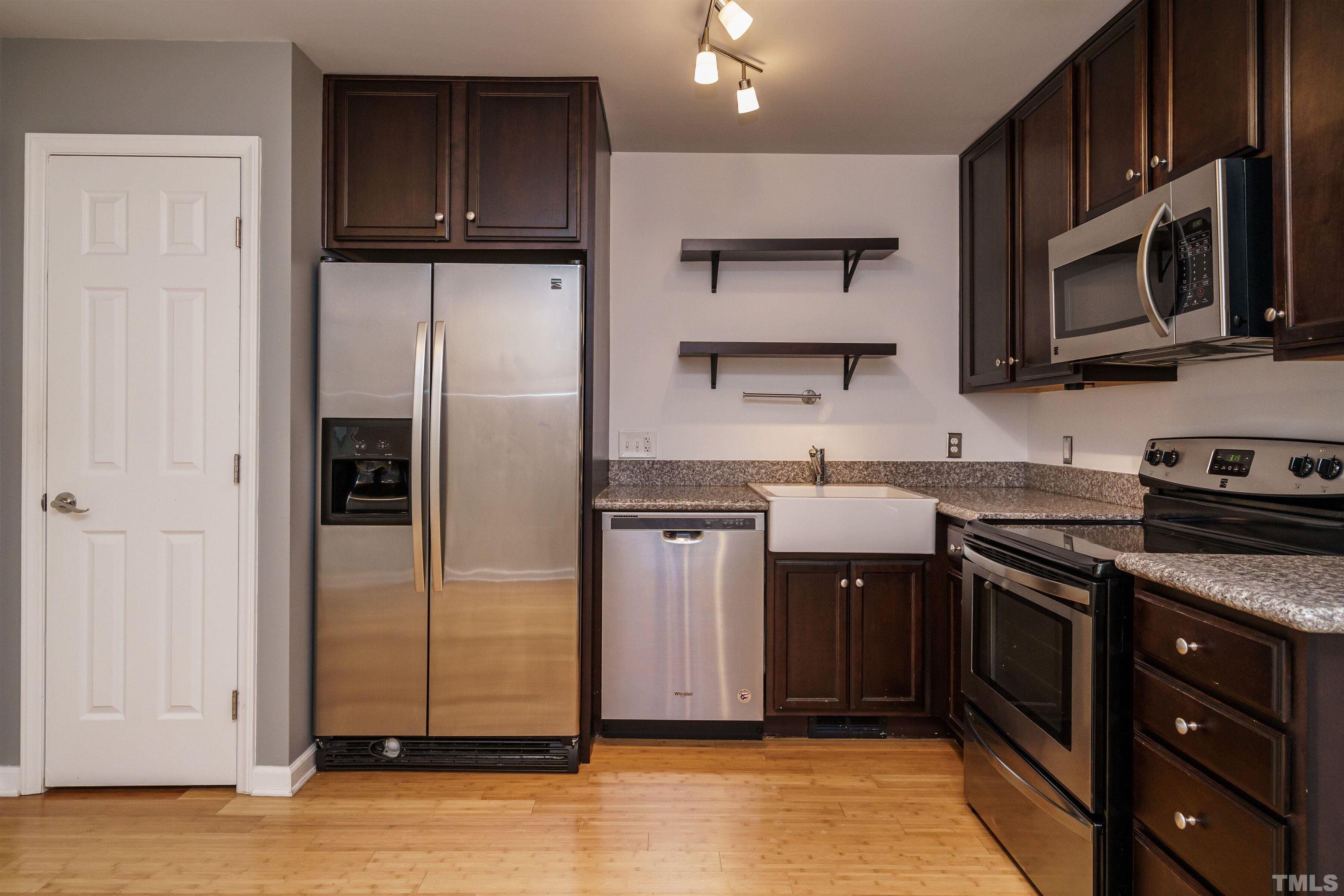2502 Noble Road Raleigh, NC 27608 - Photo 9 of 19 a kitchen with stainless steel appliances granite countertop a refrigerator stove and sink