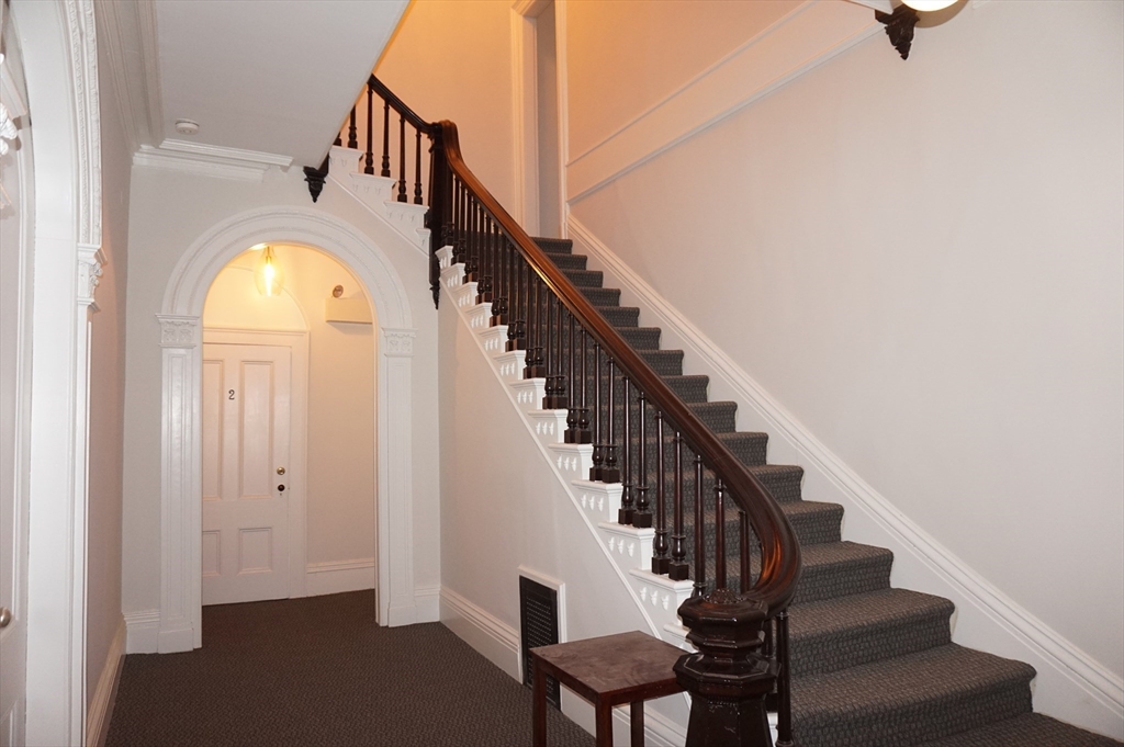 73 Elm Road, Unit 4 Newton, MA 02460 - Photo 4 of 12 a view of entryway and hall with wooden floor