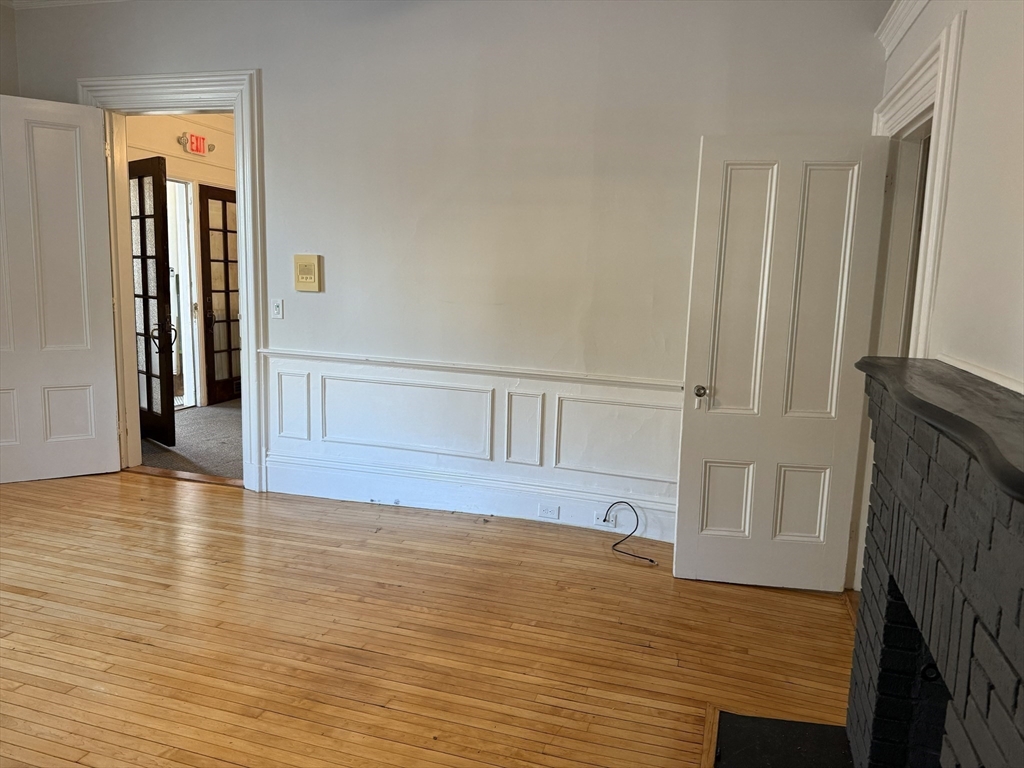 73 Elm Road, Unit 4 Newton, MA 02460 - Photo 8 of 12 a view of empty room with wooden floor and fan