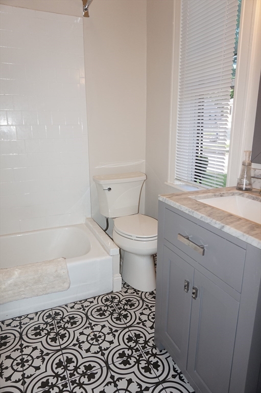 73 Elm Road, Unit 4 Newton, MA 02460 - Photo 10 of 12 a bathroom with a sink a toilet and a bathtub