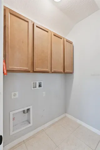 a view of a patio with table and chairs potted plants and floor to ceiling window and potted plants