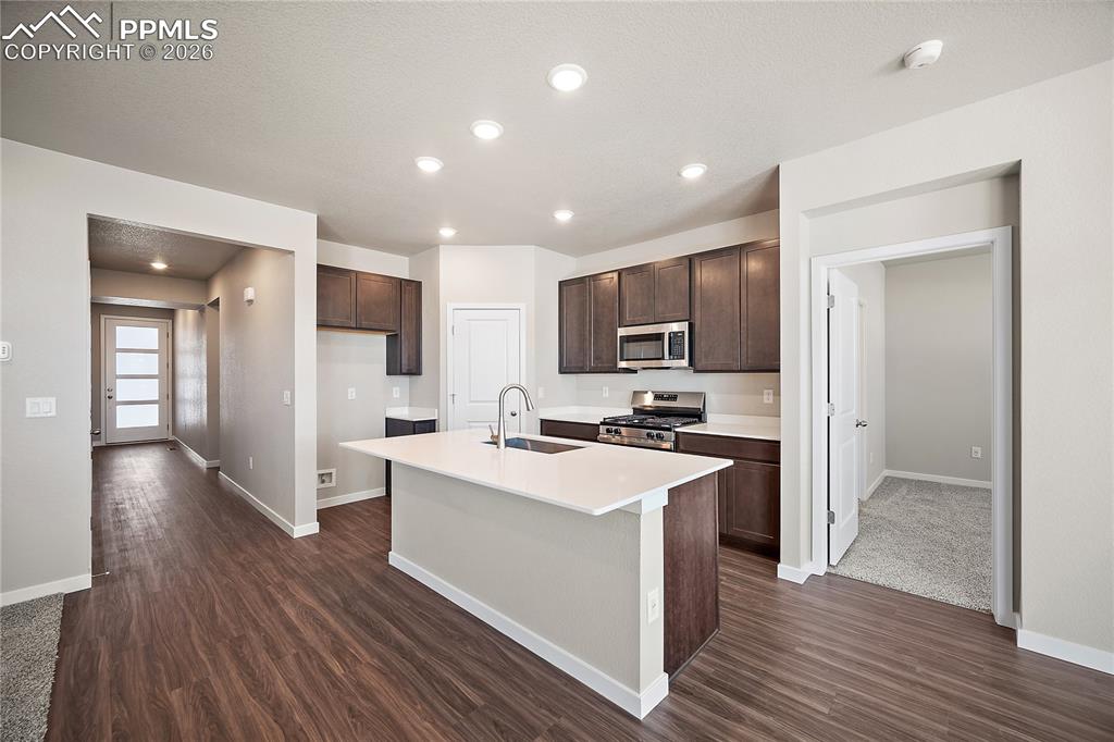 9653 Pinpoint Drive Fountain, CO 80817 - Photo 11 of 34 a view of a kitchen with cabinets stainless steel appliances a sink and a counter top space