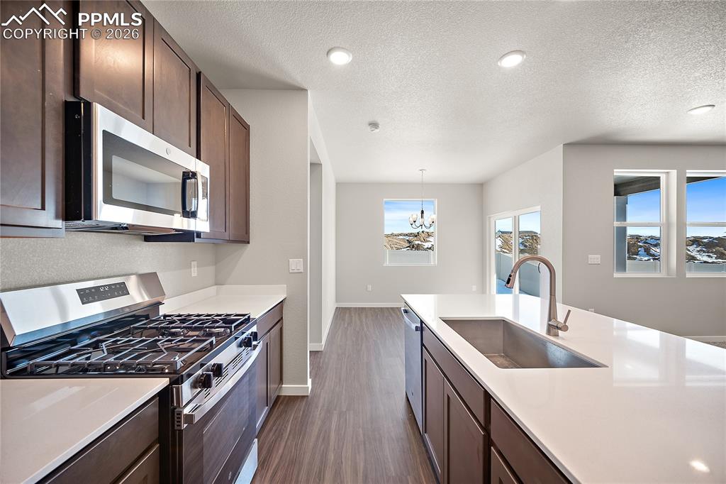 9653 Pinpoint Drive Fountain, CO 80817 - Photo 13 of 34 a kitchen with stainless steel appliances granite countertop a sink stove and refrigerator