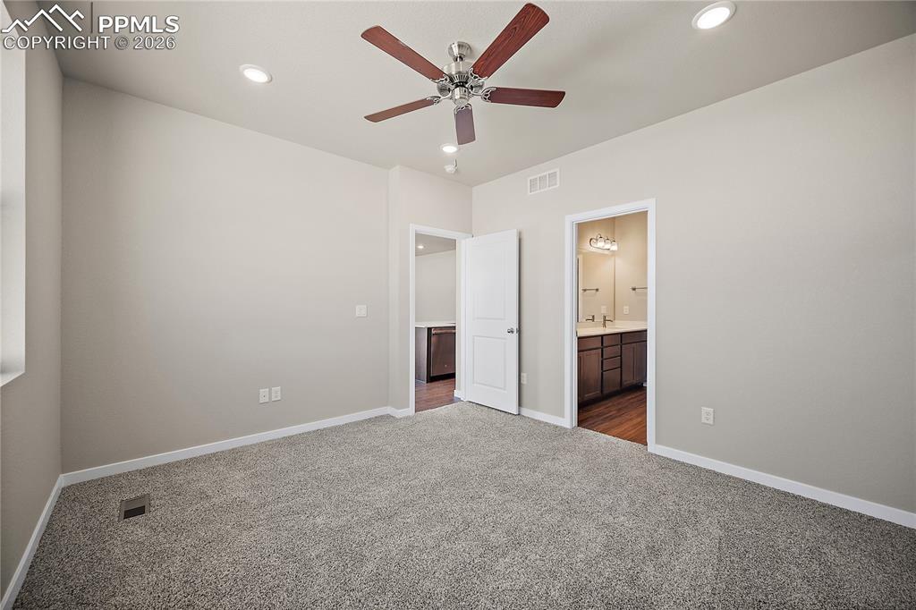 9653 Pinpoint Drive Fountain, CO 80817 - Photo 18 of 34 an empty room with closet and a ceiling fan