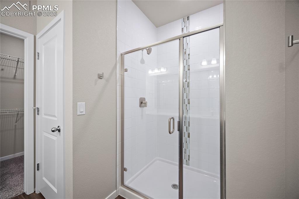 9653 Pinpoint Drive Fountain, CO 80817 - Photo 20 of 34 a bathroom with a glass shower door