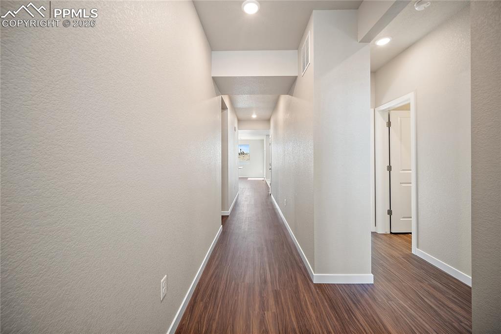 9653 Pinpoint Drive Fountain, CO 80817 - Photo 4 of 34 a view of a hallway with wooden floor