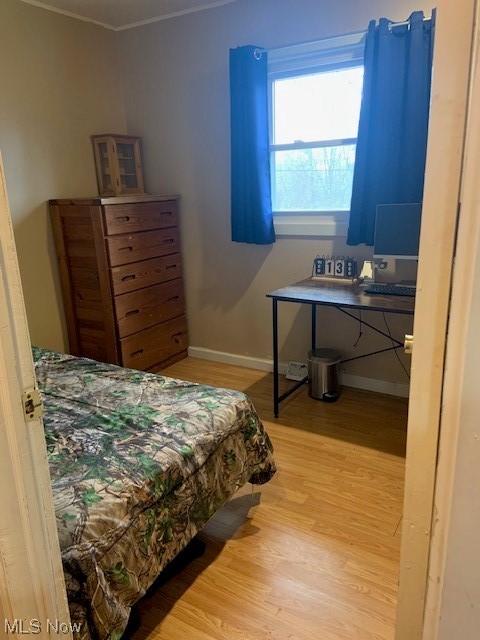4713 Highway 534 Rome, OH 44085 - Photo 17 of 21 Bedroom with light wood-type flooring and crown molding