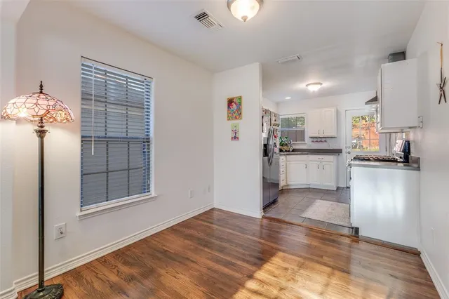 a view of a kitchen with wooden floor and a kitchen