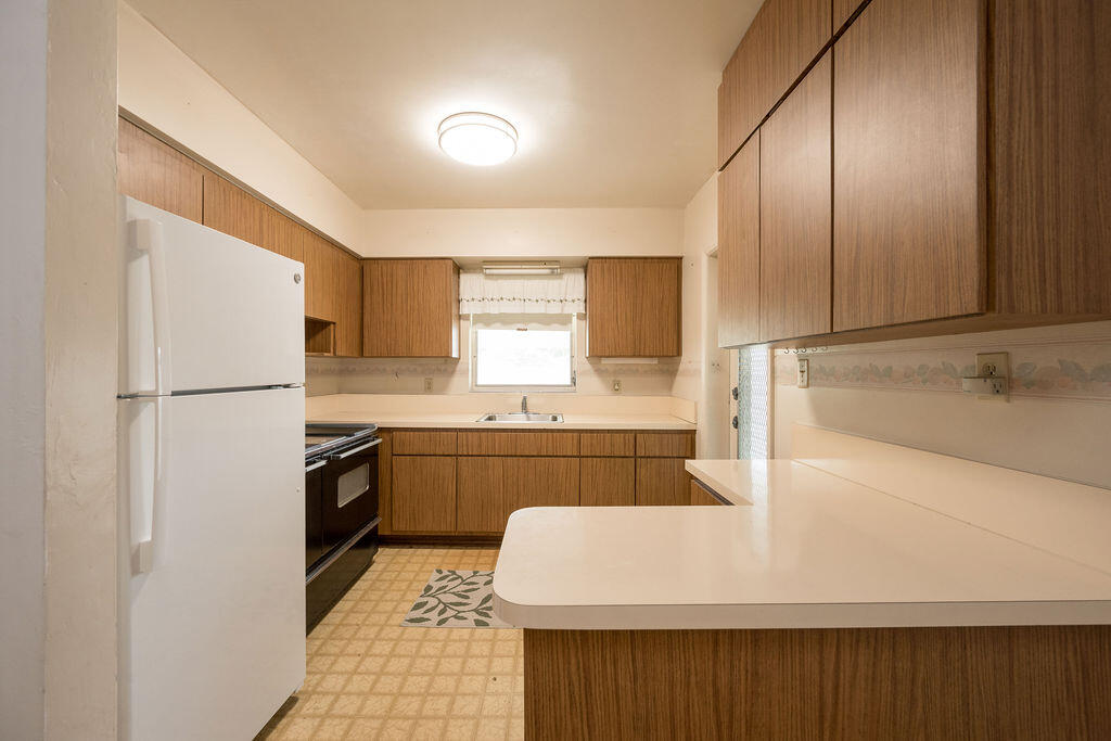 719 Washington Street Key West, FL 33040 - Photo 9 of 28 a kitchen with a refrigerator sink and stove