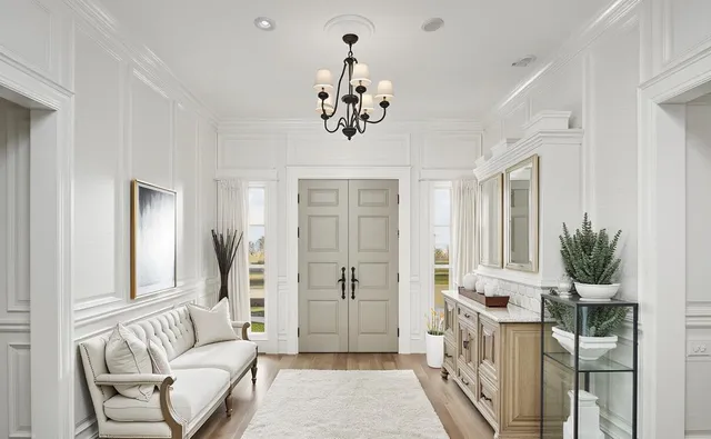 a living room with furniture a chandelier and a chandelier