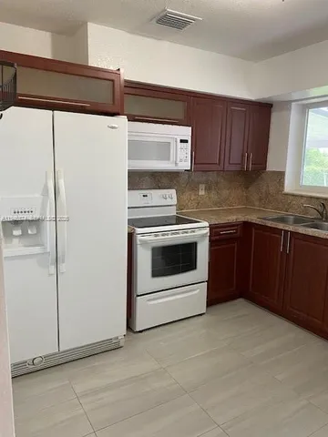 a kitchen with stainless steel appliances a stove and a refrigerator