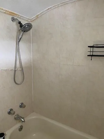 a bathroom with a shower and a bathtub
