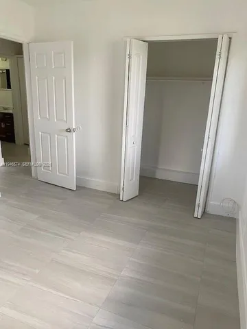wooden floor and cabinet in an empty room