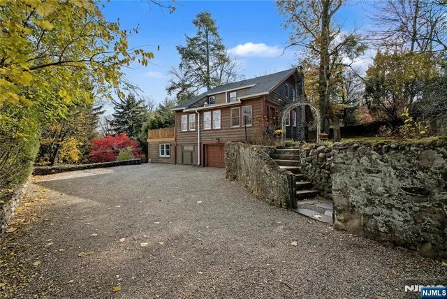 a view of a house with a yard and garage
