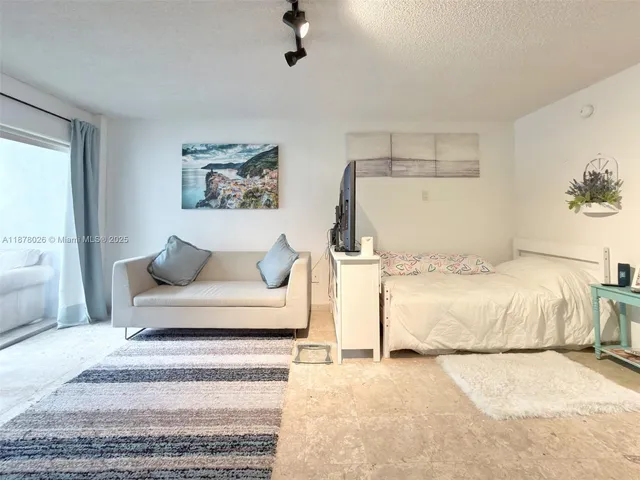 a spacious bedroom with a bed and a couch