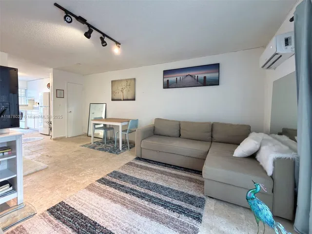 a living room with furniture and a rug