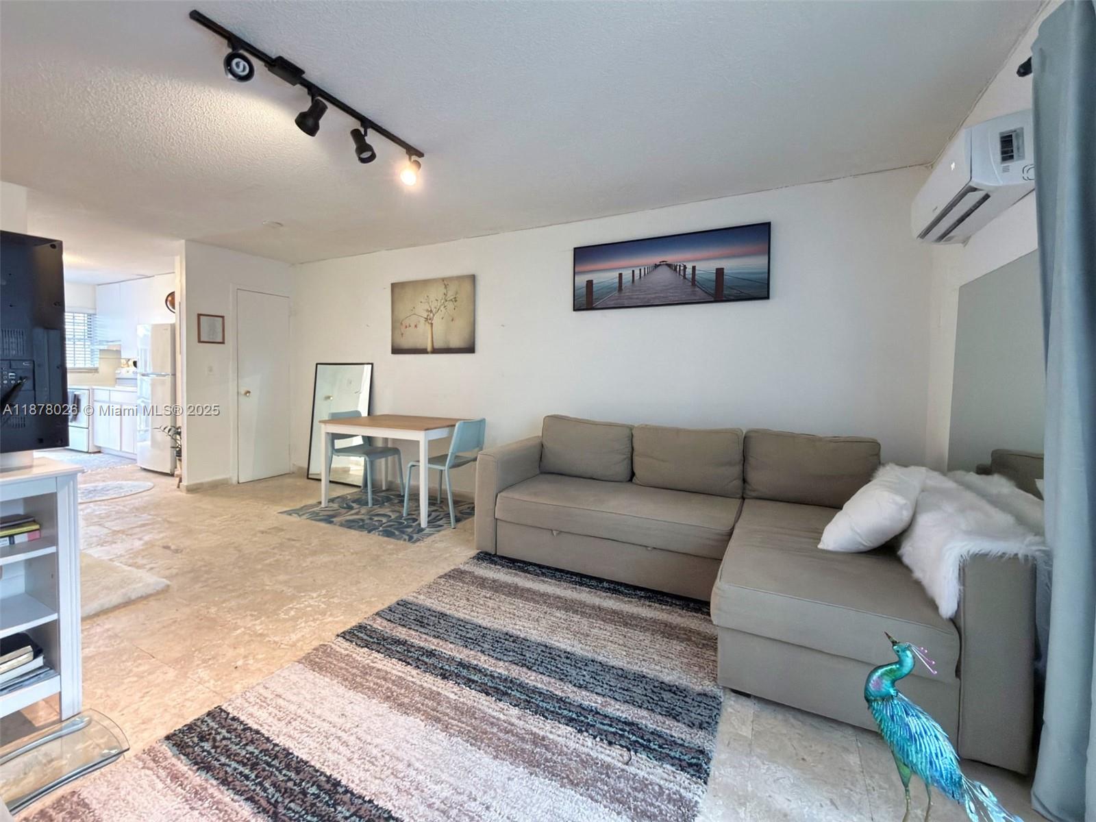 221 Meridian Avenue, Unit 211 Miami Beach, FL 33139 - Photo 8 of 20 a living room with furniture and a rug