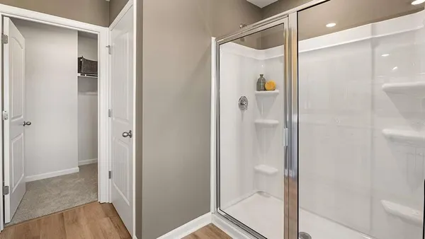 a bathroom with a shower and a glass door