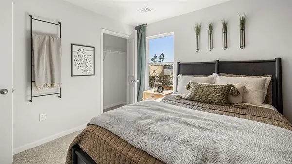 a bedroom with a large bed and a window
