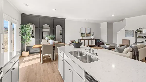 a view of a kitchen with a sink and living room