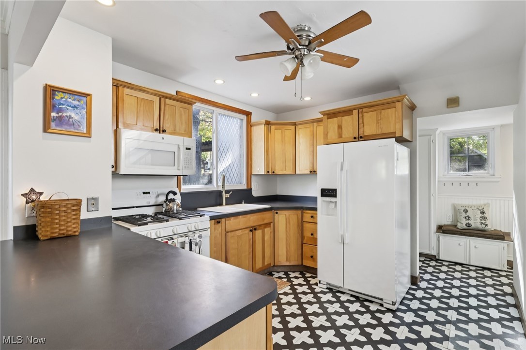 3054 East Overlook Road Cleveland, OH 44118 - Photo 10 of 50 Kitchen featuring dark countertops, white appliances, recessed lighting, light floors, and ceiling fan