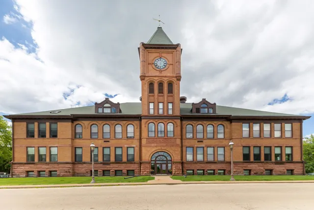 a front view of a residential apartment building with a yard