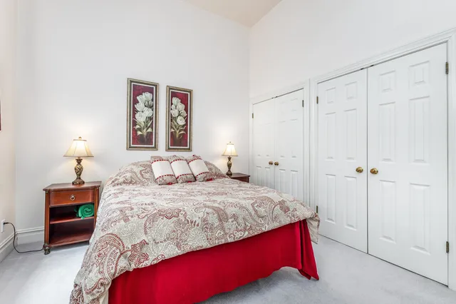 a bedroom with a bed and a lamp