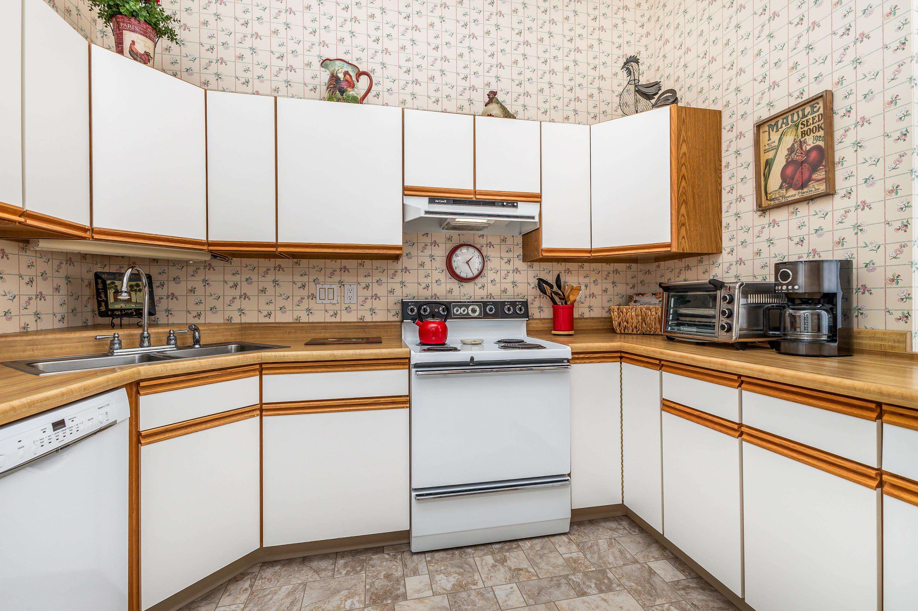 411 South Prospect Street, Unit 204 Galena, IL 61036 - Photo 7 of 18 a kitchen with stainless steel appliances granite countertop a sink and a stove