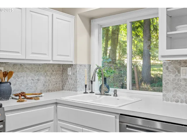 a kitchen with a sink and large window