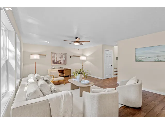 a living room with furniture and chandelier