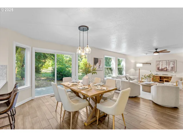 a dining room with furniture a chandelier and wooden floor