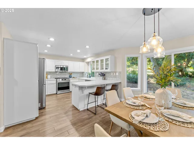 a living room with kitchen island furniture and a chandelier