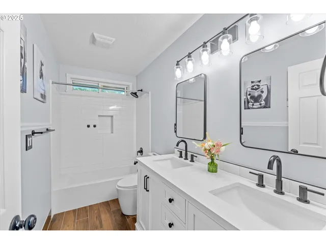 a bathroom with a double vanity sink mirror double and shower