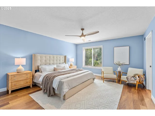 a bedroom with a bed and a large window