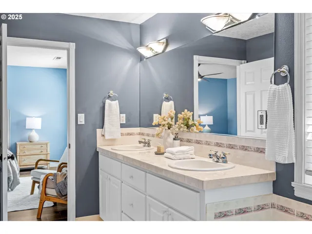 a bathroom with a sink a toilet and a window