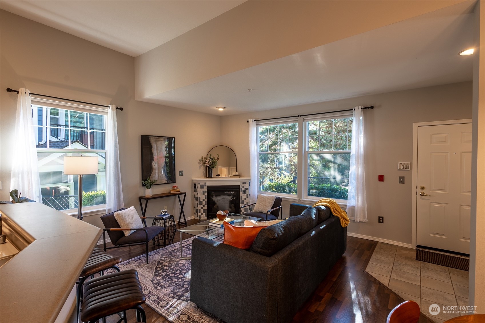 16125 Juanita Woodinville Way Northeast, Unit 2201 Bothell, WA 98011 - Photo 11 of 35 a living room with furniture a large window and a flat screen tv