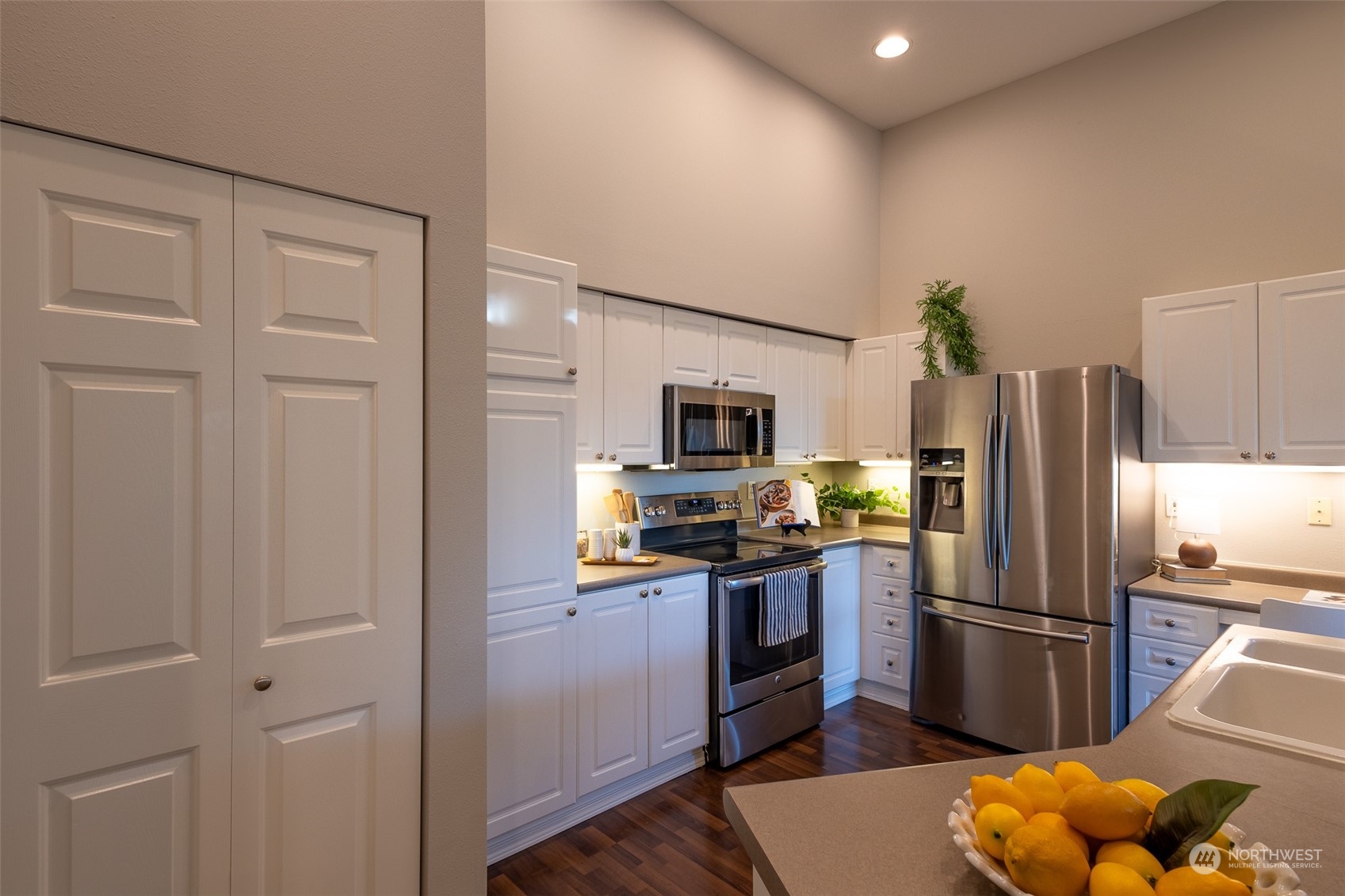 16125 Juanita Woodinville Way Northeast, Unit 2201 Bothell, WA 98011 - Photo 12 of 35 a kitchen with stainless steel appliances granite countertop a refrigerator a stove and a sink